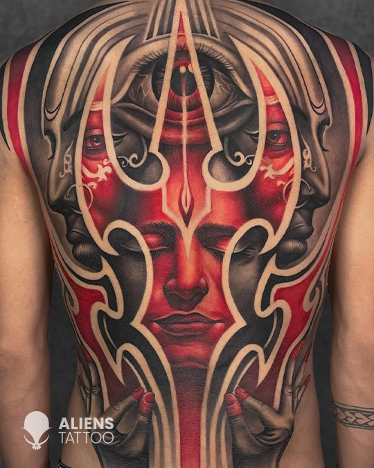 Full back tattoo of abstract red face with third eye and flowing ornamental lines in color realism style
