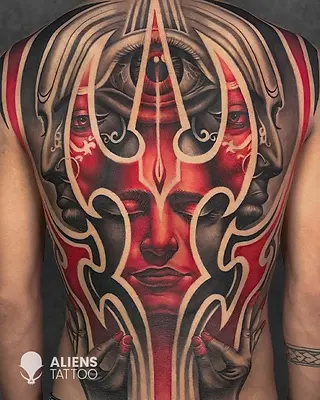 Full back tattoo of abstract red face with third eye and flowing ornamental lines in color realism style