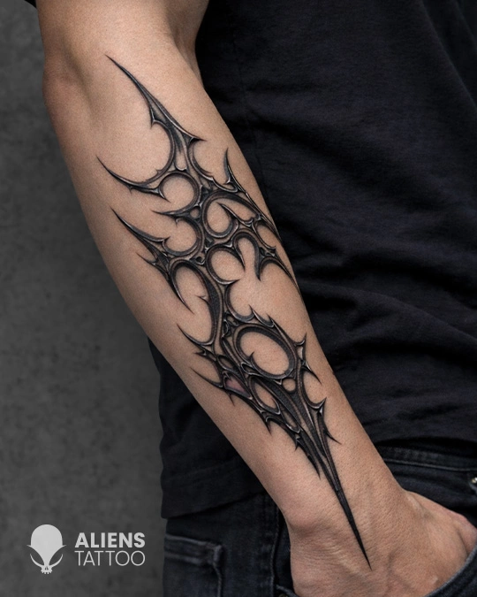 Futuristic biomechanical abstract tattoo on forearm with sharp black linework