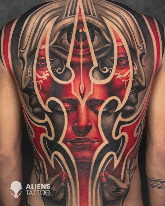 Full back tattoo with symmetrical red and black surreal mask design at best tattoo studio in Delhi GK1
