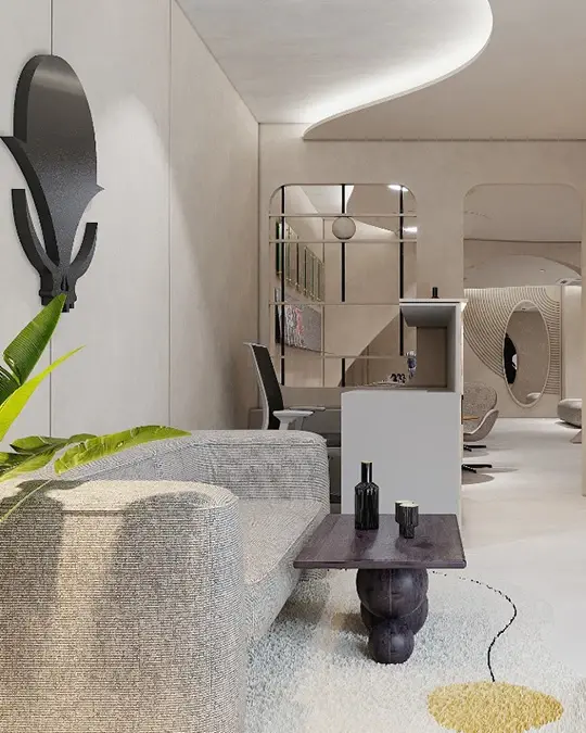 Modern room with gray sofa, wooden table with two black vases, wall art, and plants. Curved ceiling and neutral tones create a calm vibe at best tattoo studio in delhi