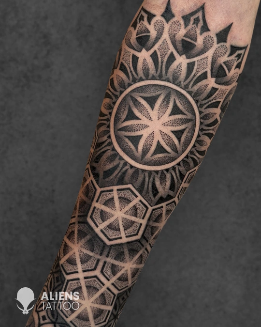 Fine line geometric arm tattoo with circular symmetry done at the best tattoo studio in Hyderabad