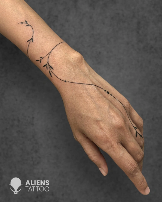 Minimalist vine wrist tattoo with fine lines done at the best tattoo studio in Hyderabad