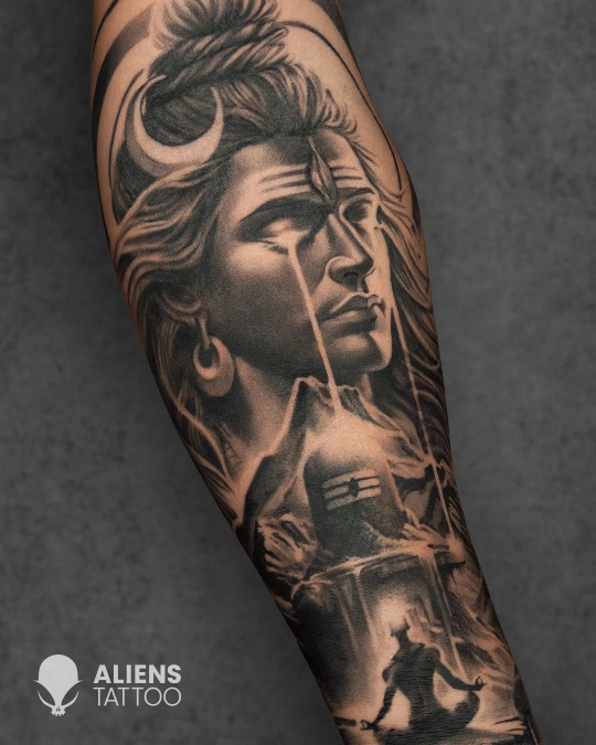 Detailed Lord Shiva tattoo with trishul and crescent moon on forearm in black and grey realism style