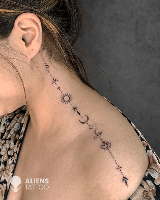 intricate geometric spiritual spine tattoo for women