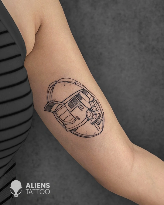Minimalist line art bus tattoo on forearm in geometric outline style