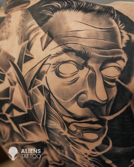 Best tattoo studio in gurgaon creating detailed black and grey portrait tattoo with geometric elements