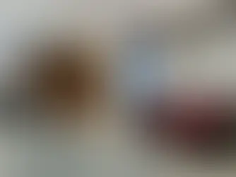 Interior of Aliens Tattoo studio in Bangalore featuring modern tattoo chairs, wooden partitions, merchandise rack, and luxury waiting area with red chairs and alien logo wall design