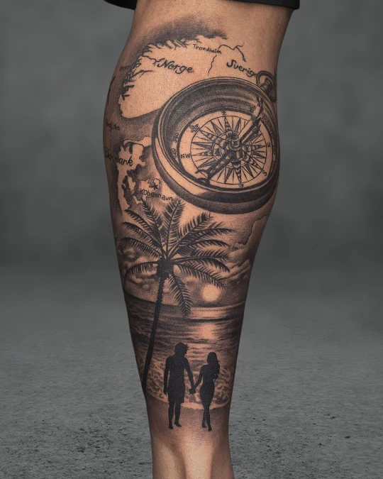 Black and grey travel tattoo featuring a compass and map on a man’s leg, symbolizing adventure and exploration.