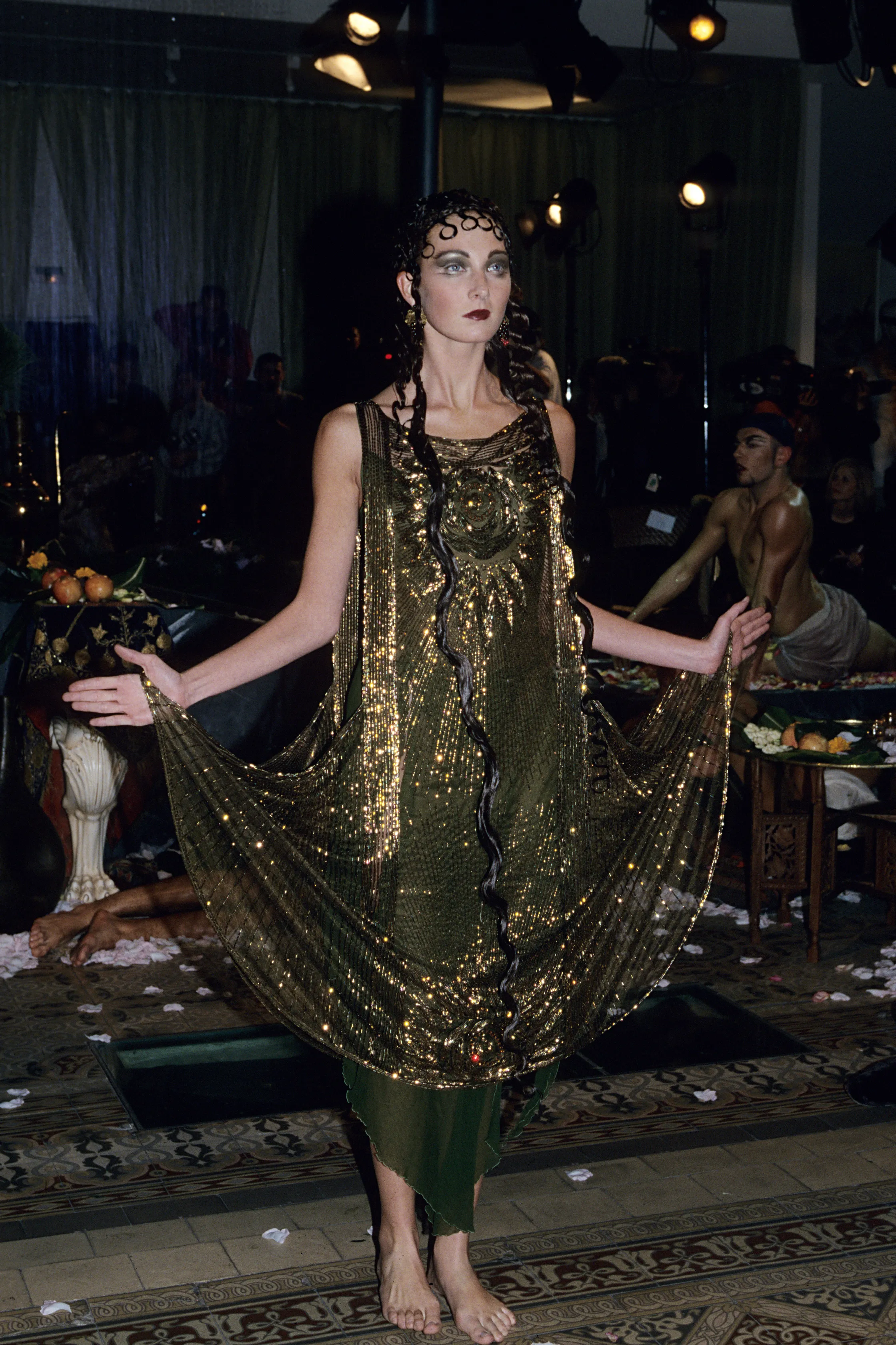 A woman in a classical golden olive dress.