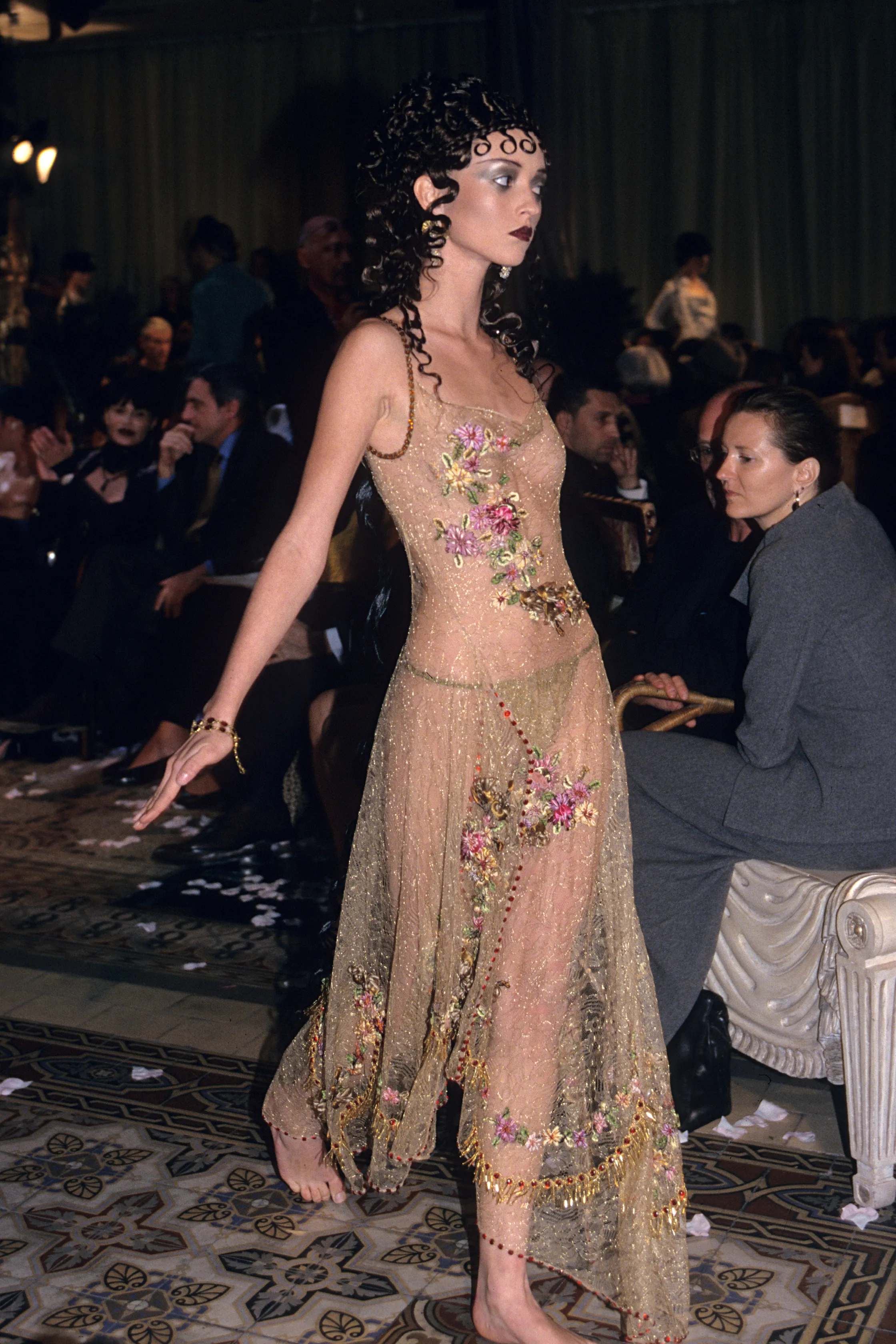 A woman in a sheer classical dress