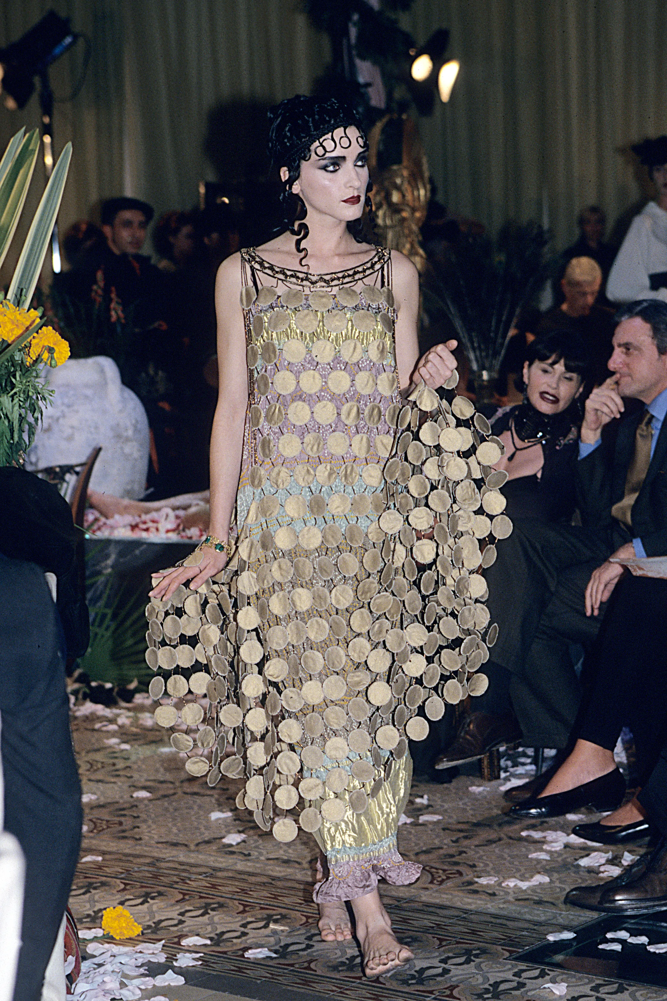 A woman in a golden circle pattern classical dress.