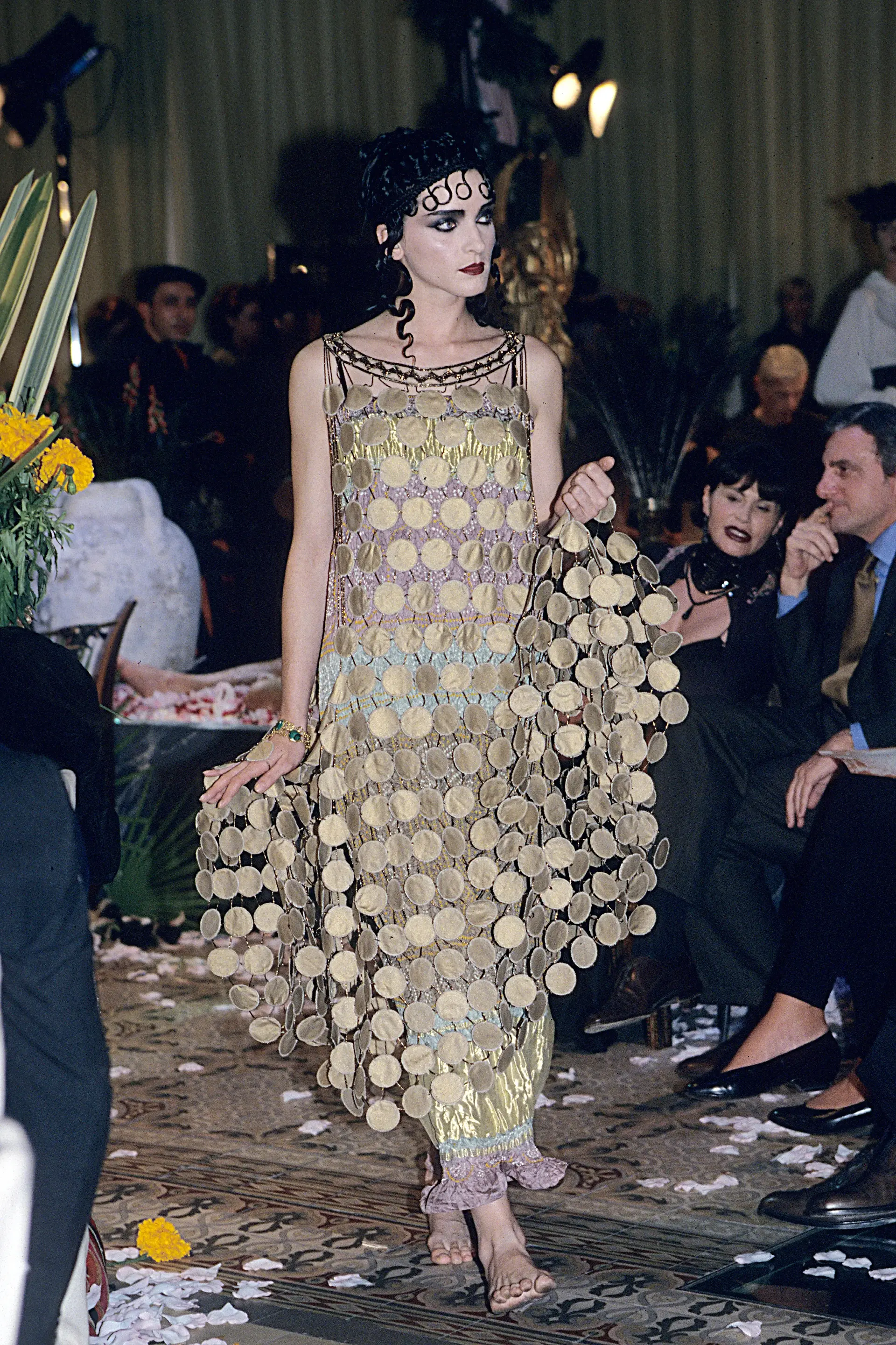A woman in a golden circle pattern classical dress.