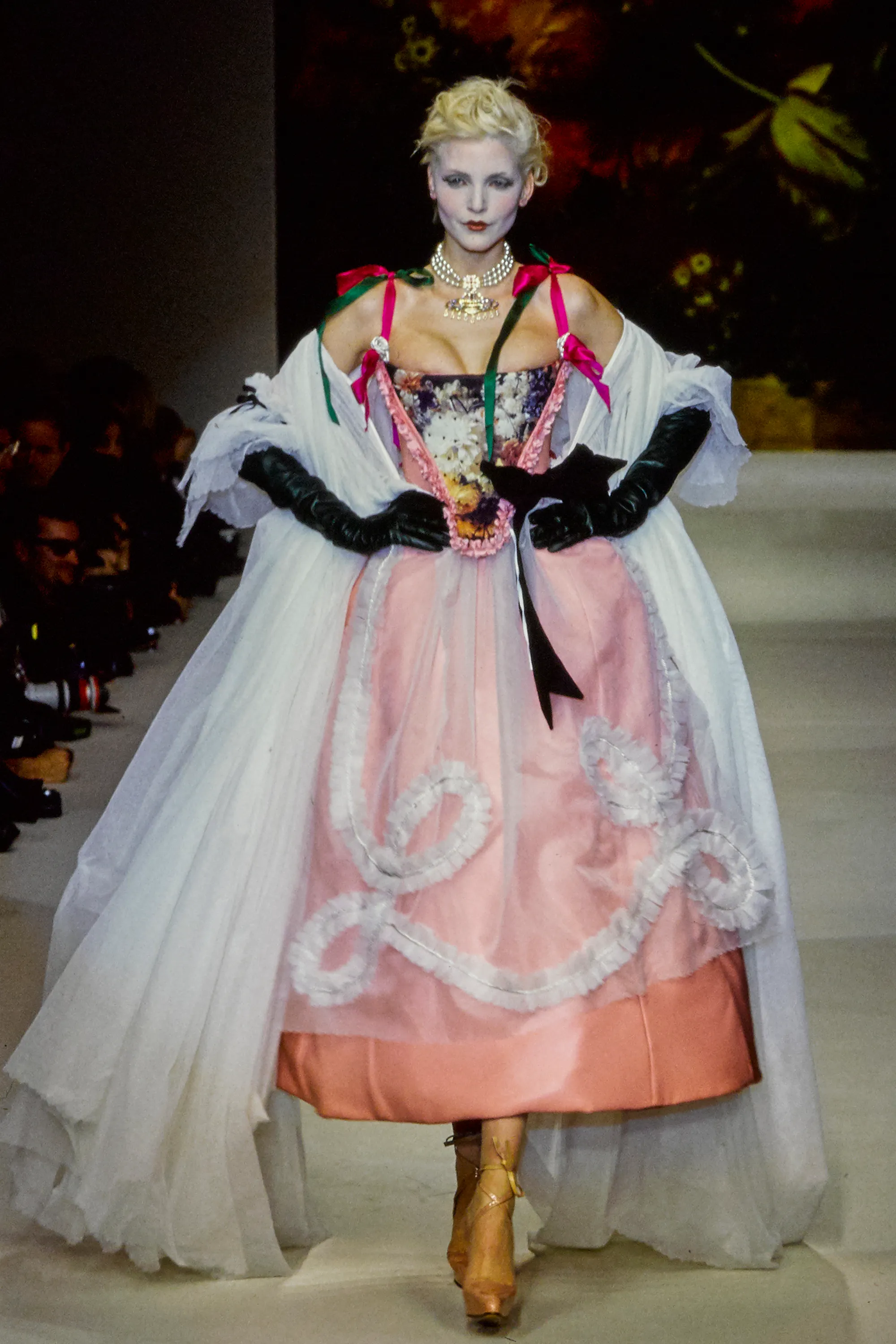 A woman in a pink French-inspired dress.