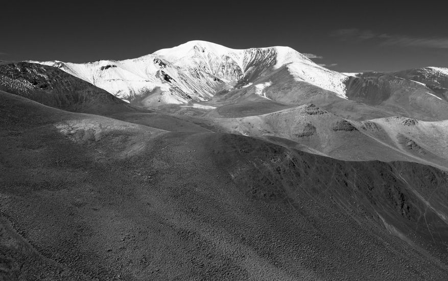 Black and white photograph of the snowed capped Acay mountain.