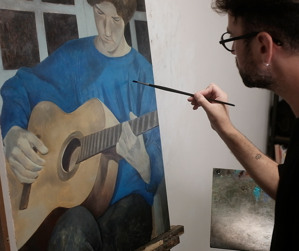 Close-up view of a local artist painting in a bright, sunlit studio