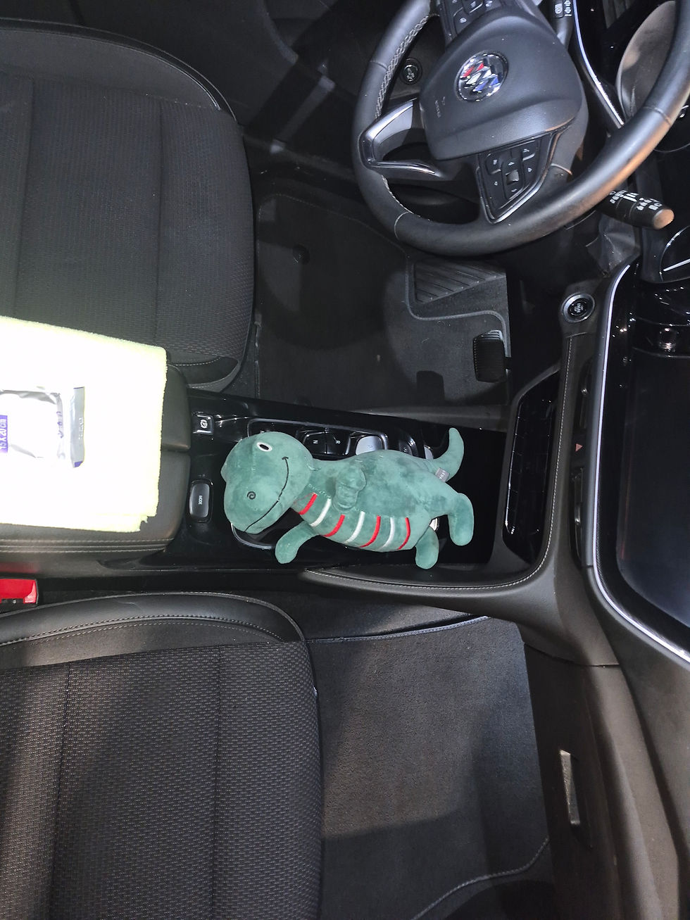 Buick Encore GX center console after professional interior detailing by Primate Detailing in 32258 - clean cloth interior with dinosaur plush