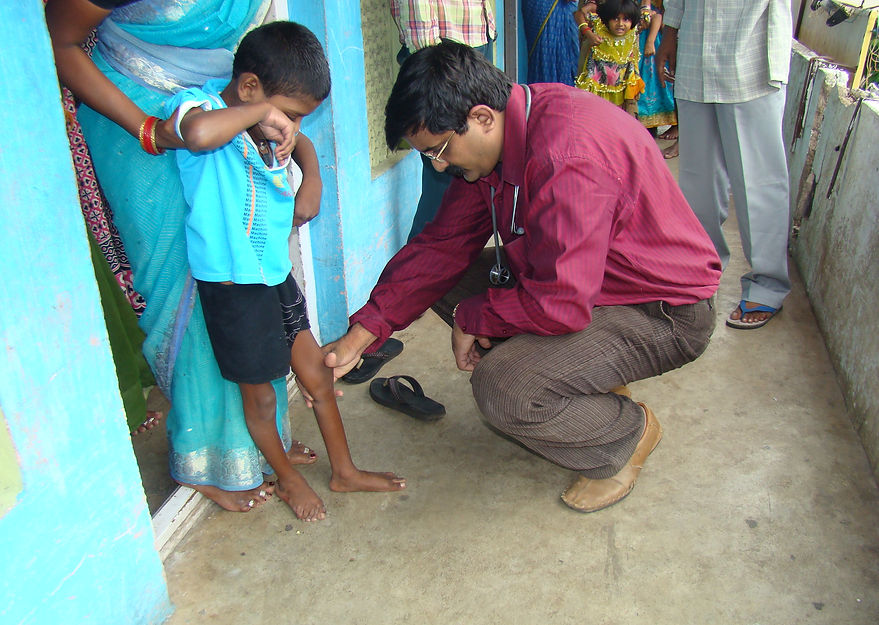Dr Kiran in 2010 checking the foot of a pediatric patient