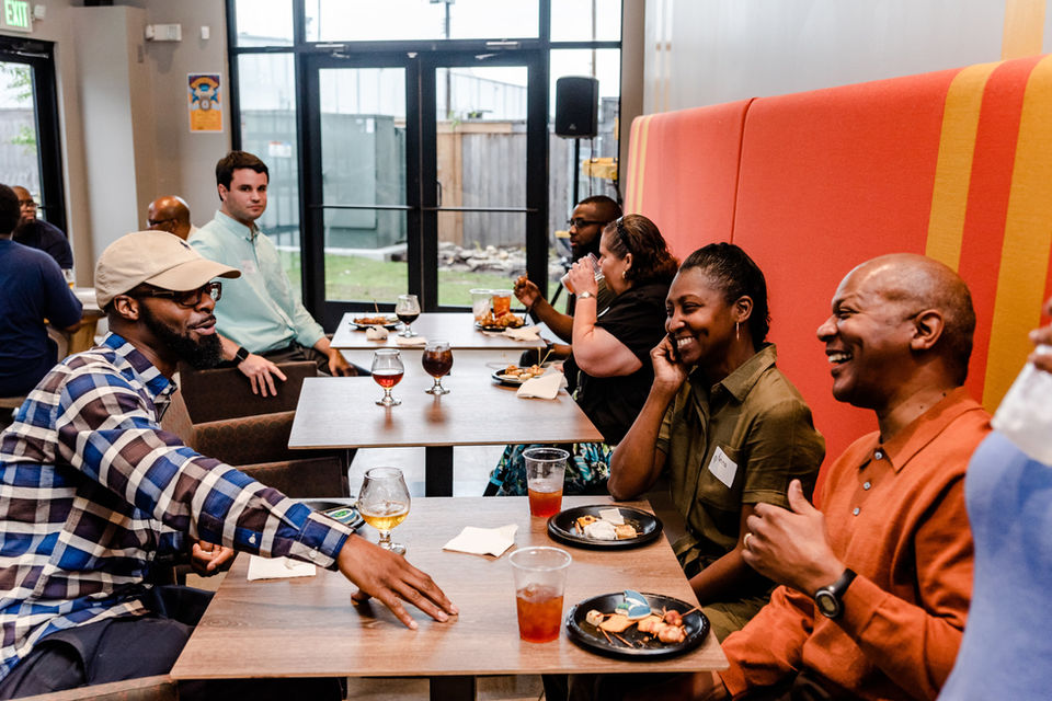 Students in adult career training networking at a social event.
