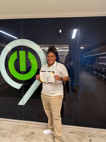 Student holding a certificate for the Tech901 admissions process.