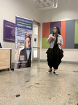 Woman presenting Adult Career Training near a Tech901 banner.