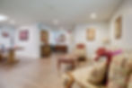 Bright residential living room with wood flooring and traditional furnishings