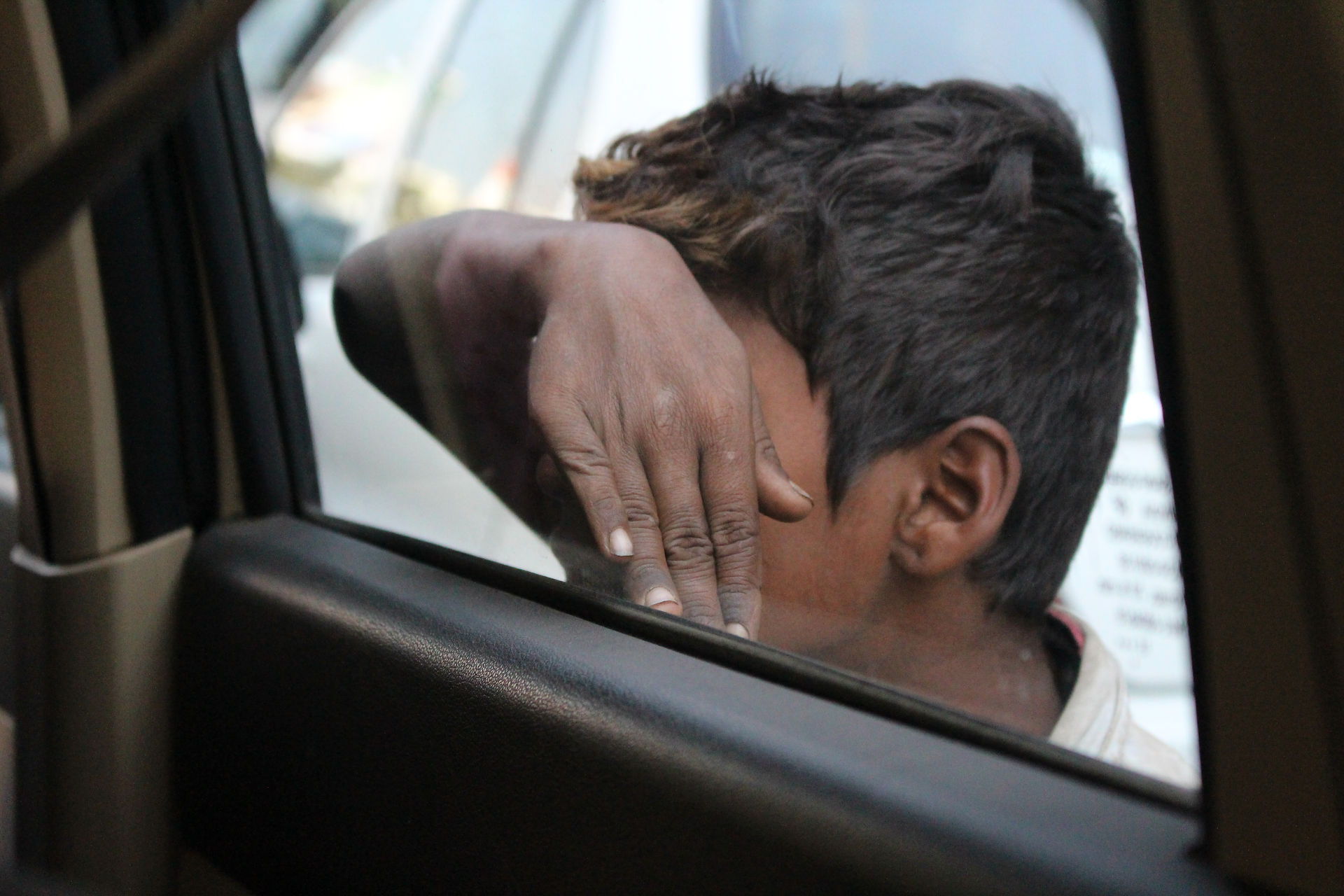 Little boy begging at our car