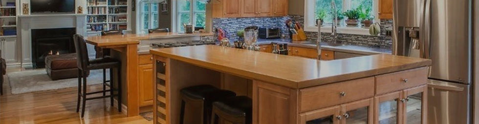 A beautiful kitchen with a wood island and tile backsplash