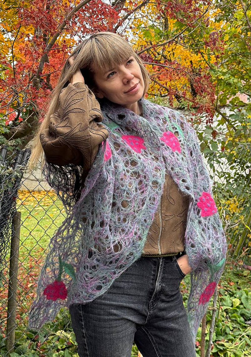 Thumbnail: Purple-green triangle mohair scarf with felted red tulips with a smiling woman holding her arm up