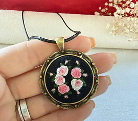 hand-embroidered-pink-rose-pendant-in-hand.jpg