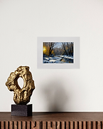 Golden Winter Whispers by Marion Dutton, 8x12 acrylic painting of a snowy creek and golden sunrise, matted to 12x16, 2025