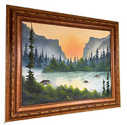 A warm evening just as the sun is setting behind the hill a mist grows on the lake