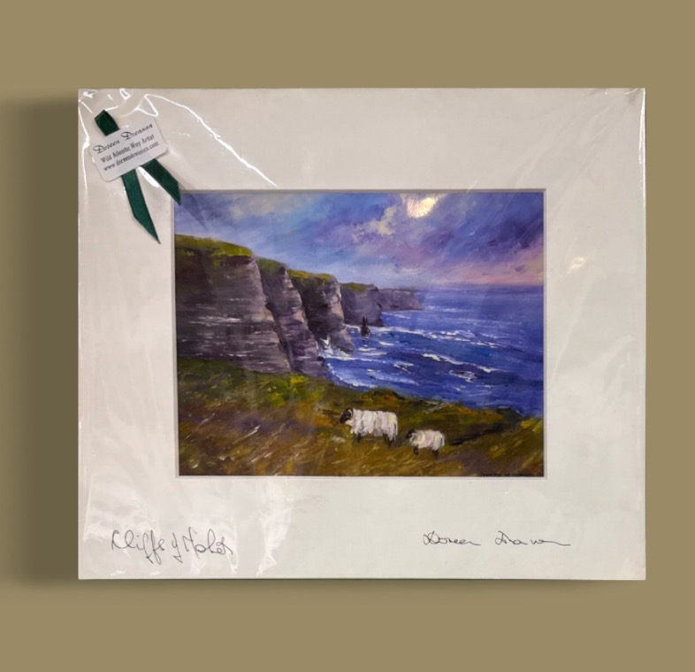 Cliffs of Moher by Doreen Drennan, matted coastal artwork shown against a neutral tan background.
