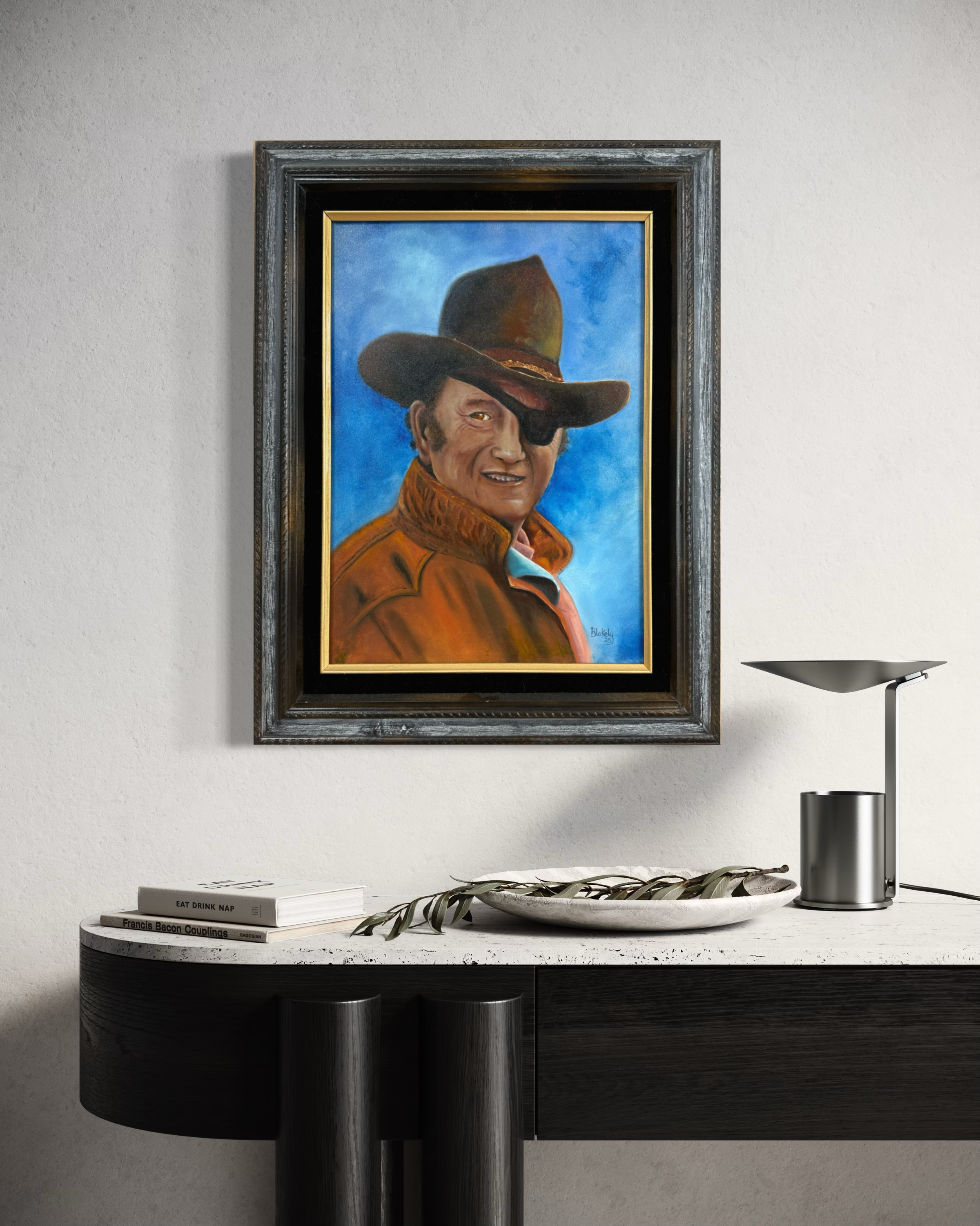 The Duke John Wayne oil portrait displayed in an interior setting to show the framed painting to scale