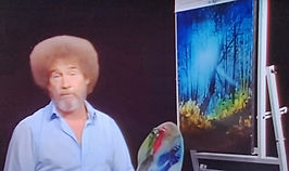 Bob Ross painting a landscape on television during The Joy of Painting.