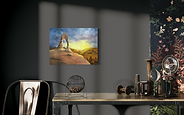 Collector landscape painting with desert arch, golden glow, and deep blue clouds.