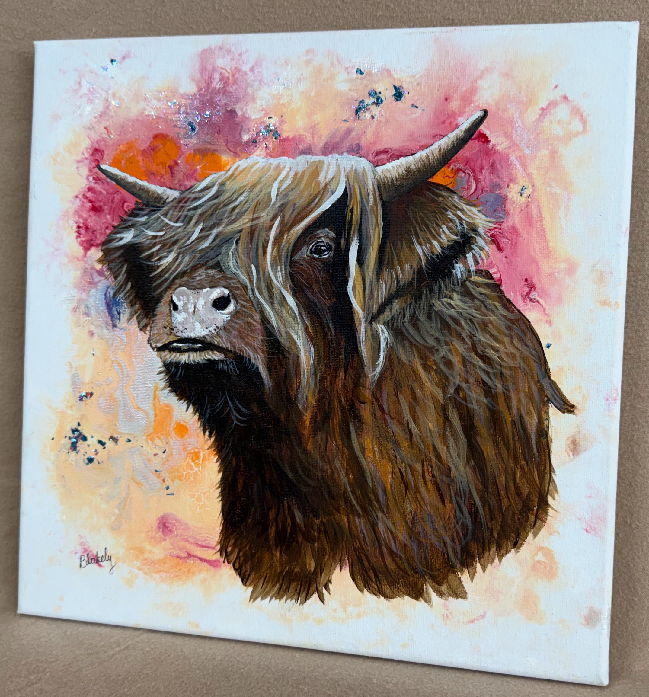 Angled view of Highland Coo painting by Hope Blakely showing the painted canvas edge.