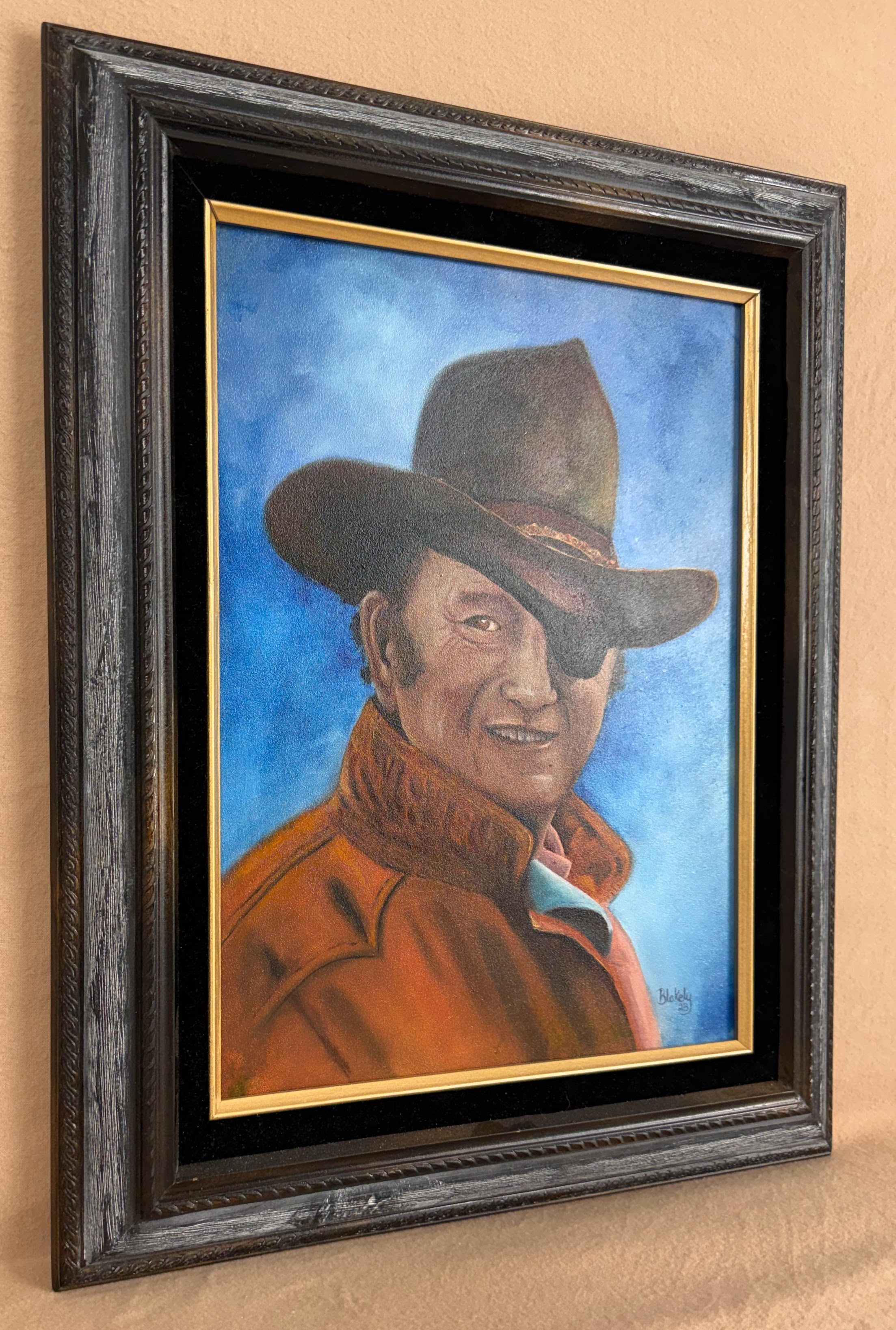 Framed view of The Duke, Hope Blakely’s original John Wayne Rooster Cogburn oil painting