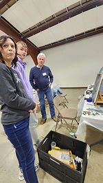 Dana Jester talking with young painter Cole and his mother during a workshop in Winchester, Indiana.