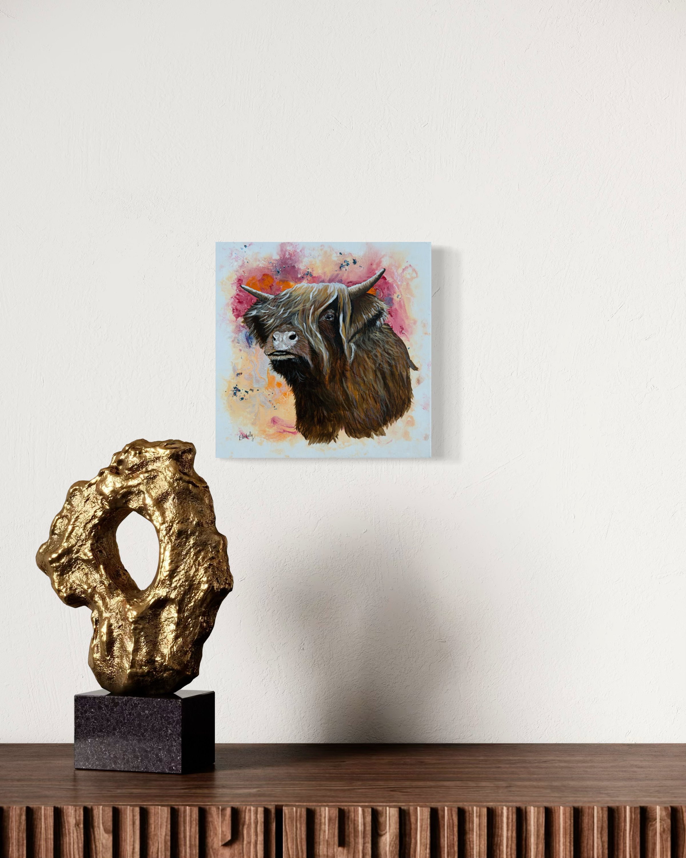 Highland Coo, original cow painting by Hope Blakely, displayed above a console with sculpture.