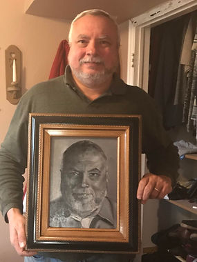 Hope Blakely’s husband Howie holding the portrait Hope painted for their anniversary in 2018 with guidance from portrait instructor David Brancato.