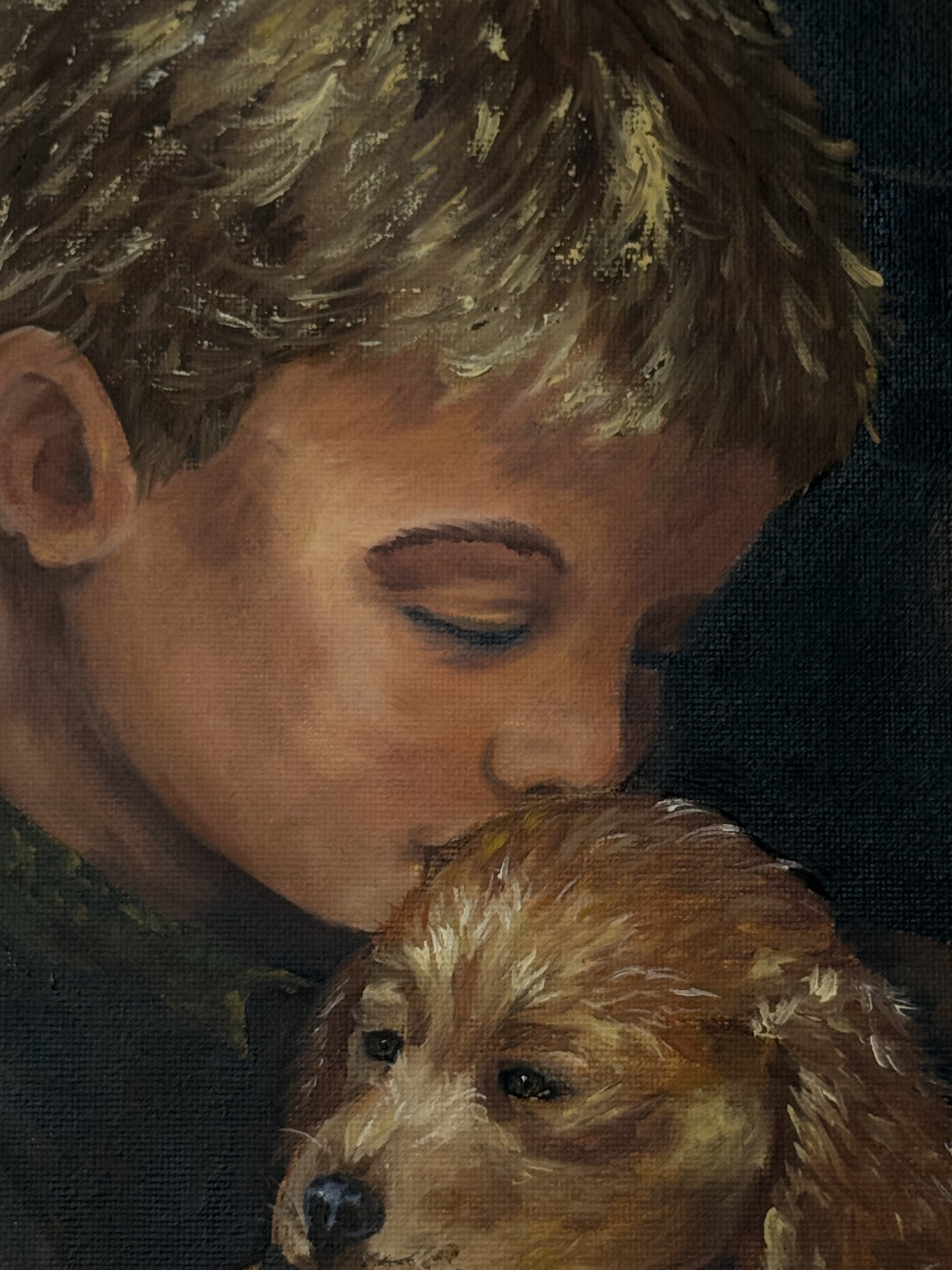 Close-up detail of Safe in His Arms showing the boy gently kissing the puppy’s head in Hope Blakely’s original oil painting.
