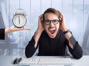 Man in black shirt, wearing glasses, screams in frustration at a desk with a keyboard, clock on hand nearby, city skyline in background.