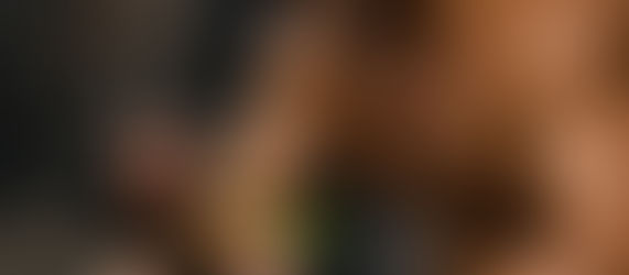 A fighter sitting on the edge of the ring or cage after a hard session, eating clean food