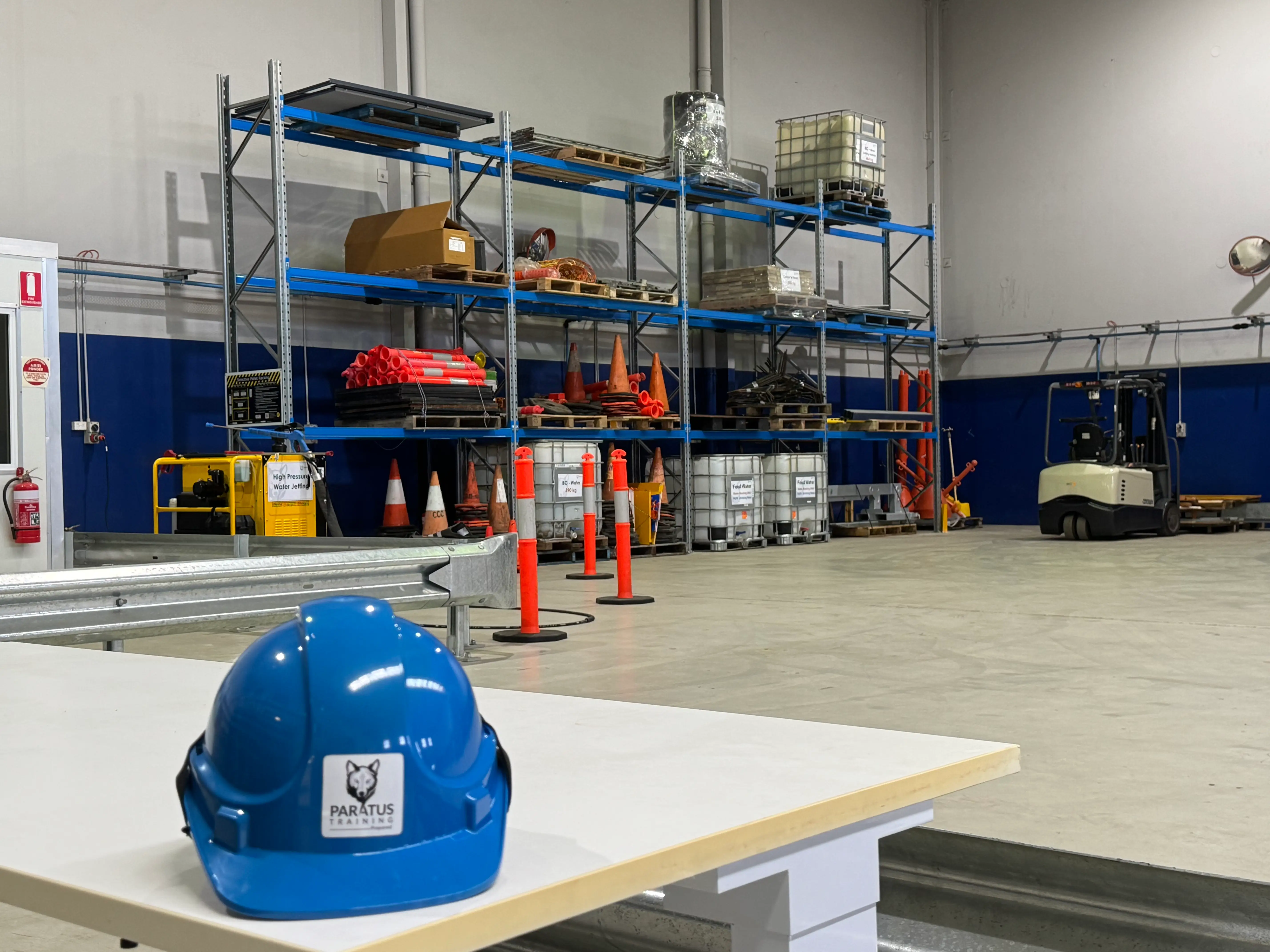 Industrial training equipment and practical learning area at the Paratus Training Bayswater facility with traffic management equipment and forklift training space.