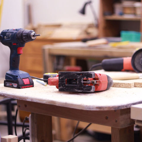 Selection of hand and power tools arranged on a workshop bench during practical hand and power tools training in an industrial training environment.