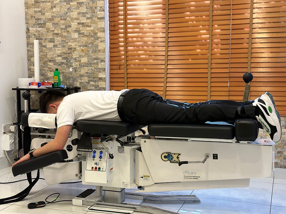Eye-level view of a chiropractor adjusting a patient on a Cox Table