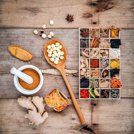 Alternative health care dried various Chinese herbs in wooden box and herbs capsule in wooden spoon