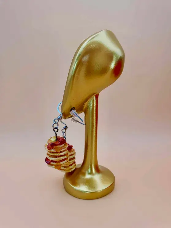 Thumbnail: Golden ear-shaped jewellery display with dangle clay pancake stack earrings show from side/rear