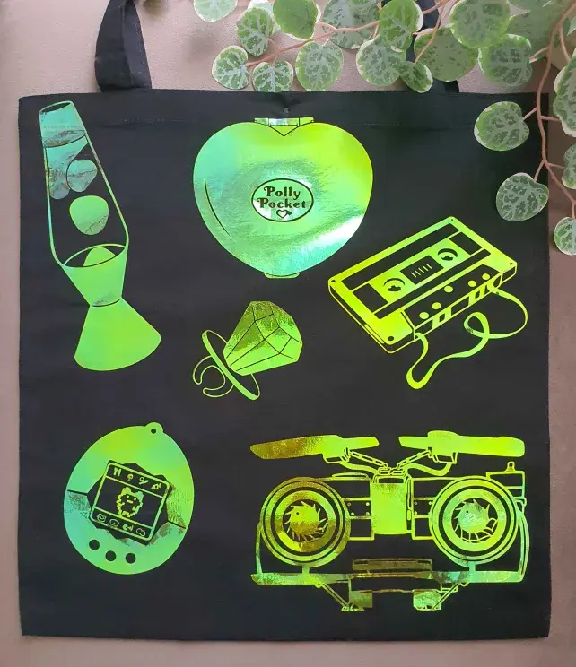 Black tote bag with retro 80s-90s vinyl designs, displayed flat.